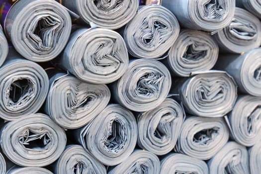 Gray Plastic rolls stacked in a disorderly manner, creating a sound of roller paper