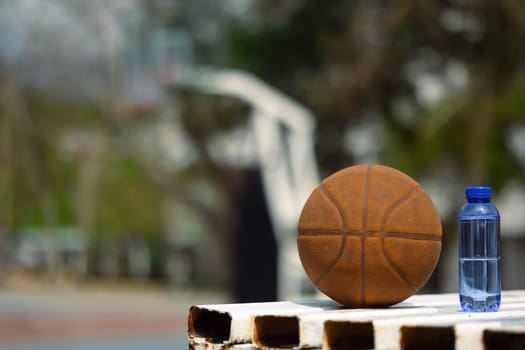 Basketball near a bottle of water on basketball court. Sport, training and competition concept.