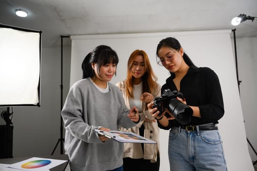 Photographer and production team working together in a professional studio.