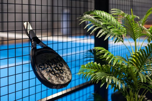 Kyiv, Ukraine. March 22, 2024 paddle tennis objects in court, racket, balls and fences outdoors, focus on fence. High quality photo