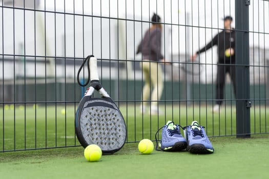 Padel tennis racket sport court and balls. Download a high quality photo with paddle for the design of a sports app or soical media advertisement. High quality photo