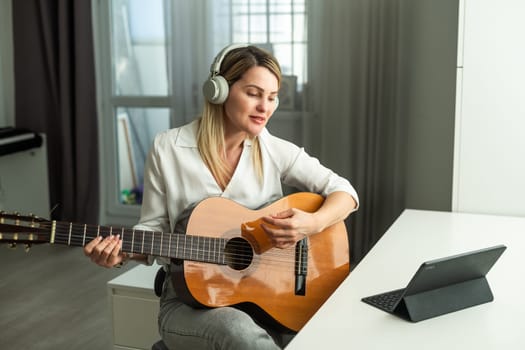 woman holding a guitar with her hands. High quality photo