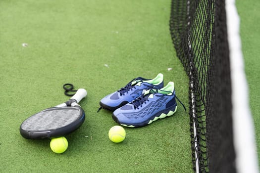 Padel tennis racket sport court and balls. Download a high quality photo with paddle for the design of a sports app or soical media advertisement. High quality photo