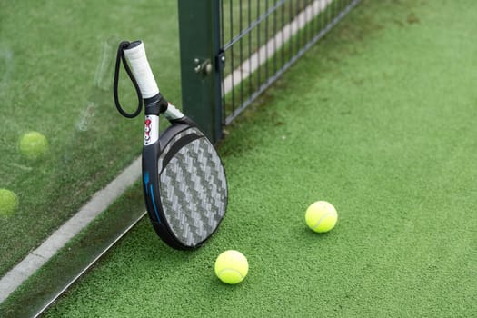 White professional paddle tennis racket with natural lighting on blue background. Horizontal sport theme poster, greeting cards, headers, website and app. High quality photo