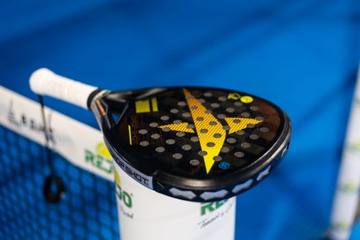 Kyiv, Ukraine. March 22, 2024 Paddle tennis: Paddel racket in front of an outdoor court. High quality photo