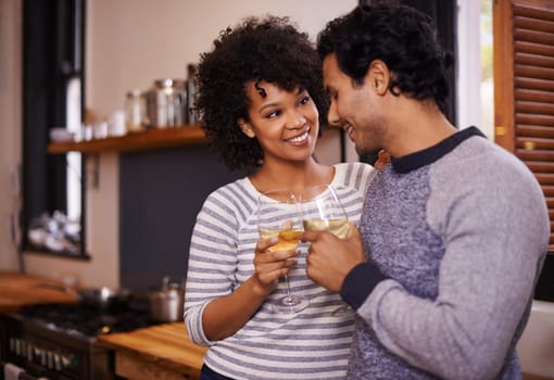 Couple, wine and cheers for love, romance and passion for romantic, dating and relationship together. Boyfriend, girlfriend and young people for interracial pair for happy and drink in kitchen.