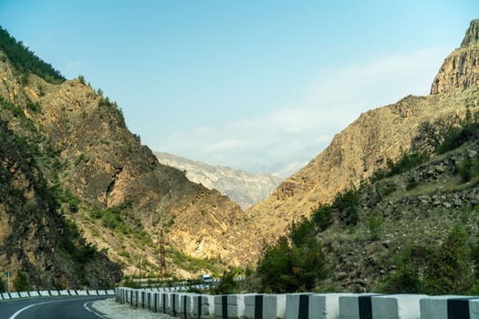 View from the car of an asphalt road in the mountainous area of Dagestan.