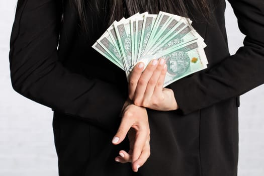 Behind her, the woman holds money as a surprise for the winner.