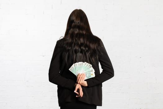 Behind her, the woman holds money as a surprise for the winner.