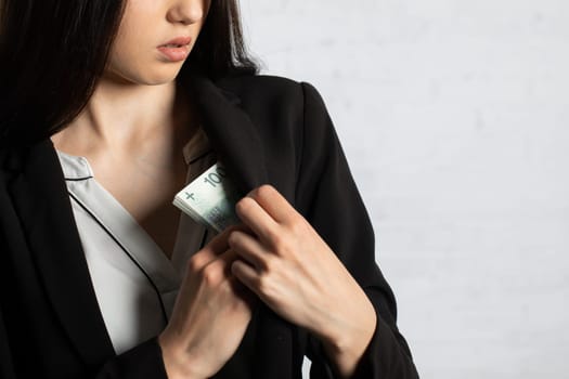 After a successful transaction, the woman puts a thick bundle of paper banknotes into her pocket.