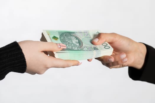 On the zoom you can see female hands full of banknotes as they exchange cash.
