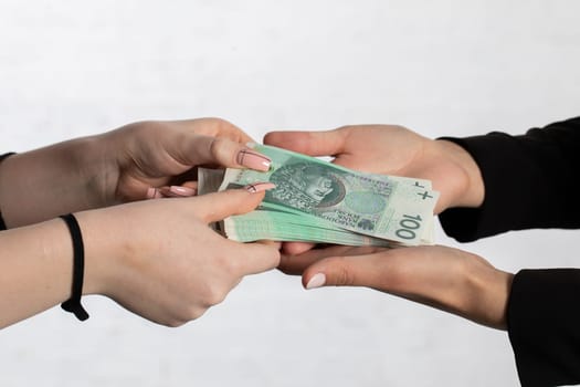 On the zoom you can see female hands full of banknotes as they exchange cash.