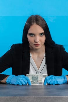 A bank employee in her position prepared for issuing a bundle of banknotes.