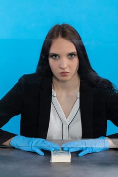 A bank employee in her position prepared for issuing a bundle of banknotes.