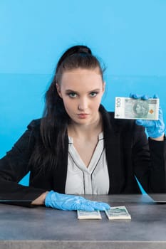 A bank employee in her position prepared for issuing a bundle of banknotes.