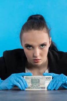 A bank employee in her position prepared for issuing a bundle of banknotes.