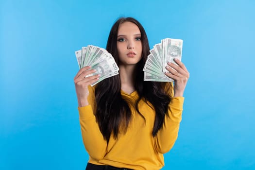 The teenager holds a large sum of money in her hand and is ready to give it to her.