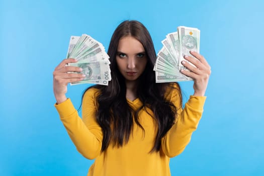 The teenager holds a large sum of money in her hand and is ready to give it to her.