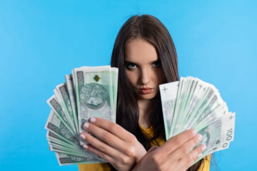 The teenager holds a large sum of money in her hand and is ready to give it to her.