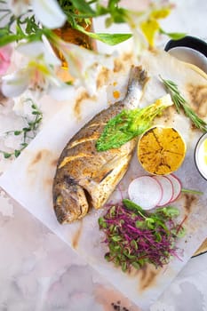 A mouthwatering dish featuring grilled Dorado fish seasoned with zesty lemon and aromatic herbs, beautifully presented on a white plate.