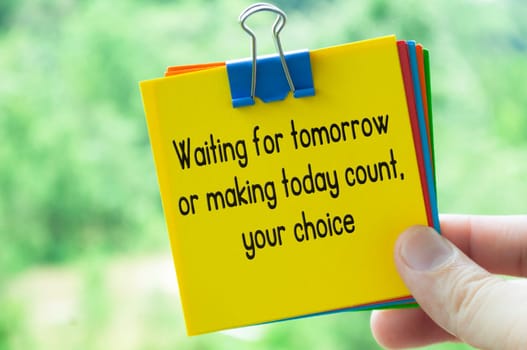 Choice about tomorrow text on sticky notes with bright nature background.