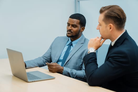 Cooperative handsome african businessman present start up project while manager listen and decide to invest. Two businesspeople making agreement, reporting data. Multicultural business. Ornamented.