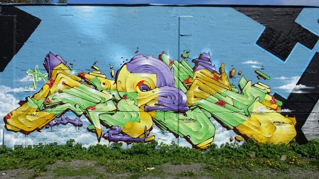 Stockholm, Snosatra, Sweden, May 23 2021. Graffiti exhibition on the outskirts of the city. Yellow.