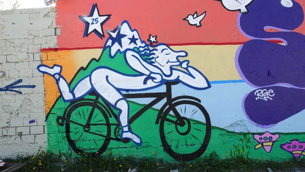 Stockholm, Snosatra, Sweden, May 23 2021. Graffiti exhibition on the outskirts of the city. Cyclist.