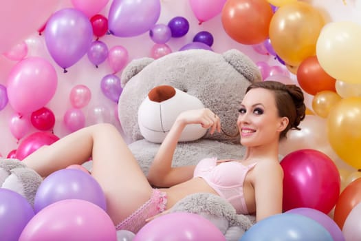 Image of smiling beautiful model posing with plush bear