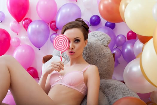 Image of flirty young brunette posing closed eyes lollipop
