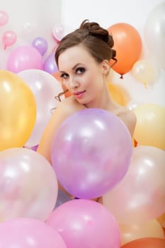 Image of attractive nude girl posing with colorful balloons