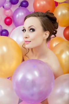 Portrait of playful brunette posing with balloons