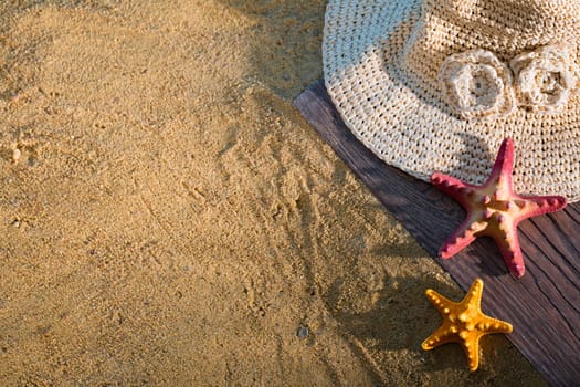 A decorative hat was laid on the sea beach and lies on a wet squeak.