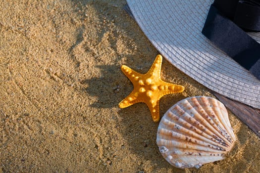 A decorative hat was laid on the sea beach and lies on a wet squeak.