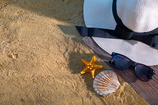 A decorative hat was laid on the sea beach and lies on a wet squeak.