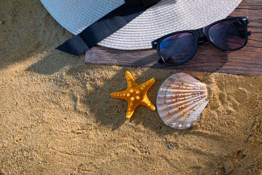 A decorative hat was laid on the sea beach and lies on a wet squeak.