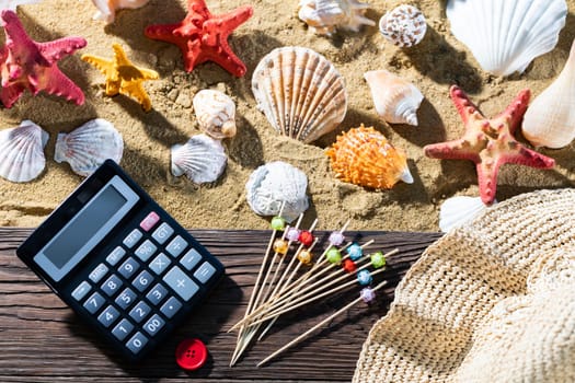 A thoughtful holiday trip with a calculator in hand. Sea beach full of felt-tip pen and shells.