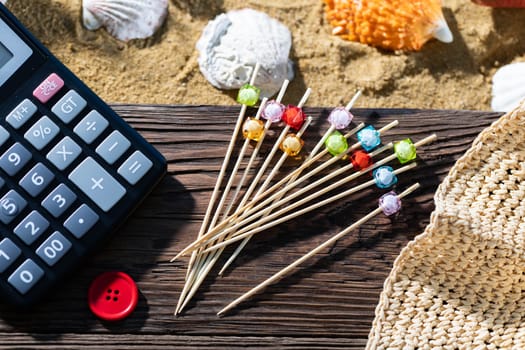 A thoughtful holiday trip with a calculator in hand. Sea beach full of felt-tip pen and shells.