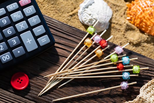 A thoughtful holiday trip with a calculator in hand. Sea beach full of felt-tip pen and shells.