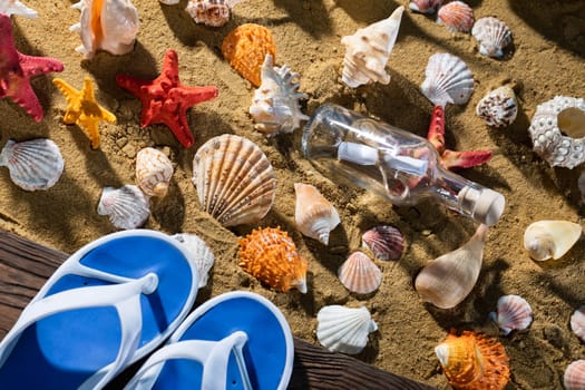 A glass bottle corked with a letter inside was on one of the sea wild beaches. Beach slippers.