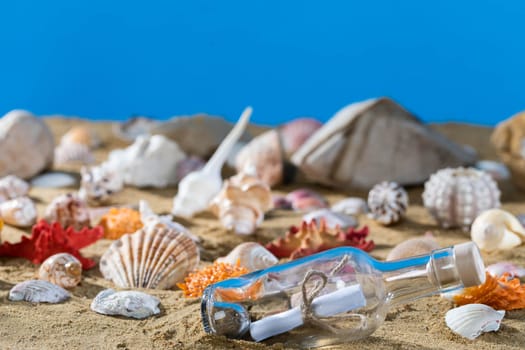 A glass bottle corked with a letter inside was on one of the sea wild beaches. Blue sky.