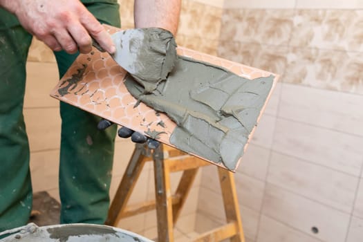 Thick cement based adhesive. A professional employee for interior finishing. Tiles - ceramic tile.