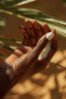 Close-up of hand applying moisturizer, representing skincare and hydration.