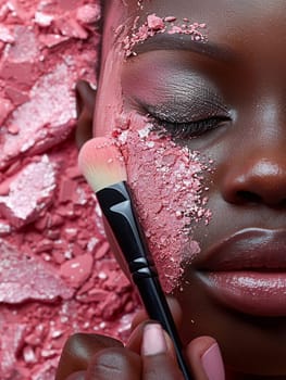 Fingers gently holding a makeup brush against a palette, symbolizing beauty routine.