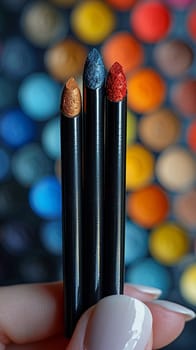 Fingers holding a colorful eyeshadow stick, depicting easy and quick makeup application.