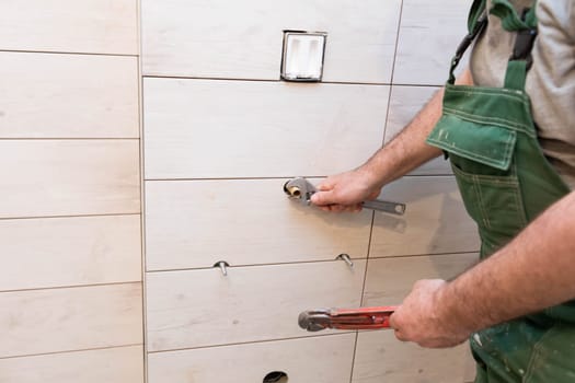 Final plumbing work prior to installing bathroom fittings. A professional worker in the hydraulic industry.