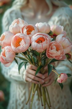 Hand holding a bouquet of fresh peonies, symbolizing natural beauty and inspiration.