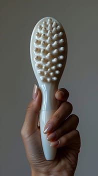 Hand holding a facial cleansing brush, symbolizing deep cleansing and skincare.