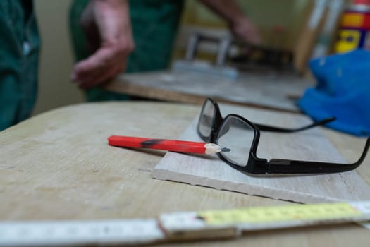 A table with the necessary tools such as a measuring cup, pencil and glasses.