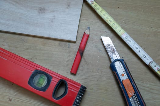 On the table lies a few measuring tools necessary for any construction work at home or on the construction site.